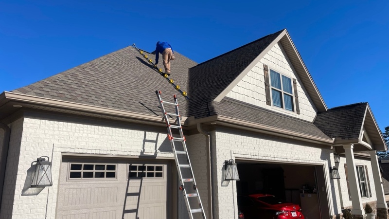 Mans Climbing on Top of the Roof