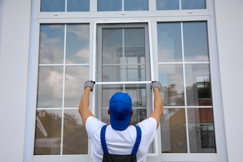 Contractor Replacing Old Window